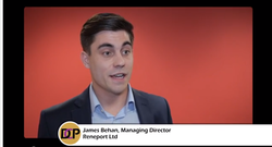 man speaking with a green screen in the background